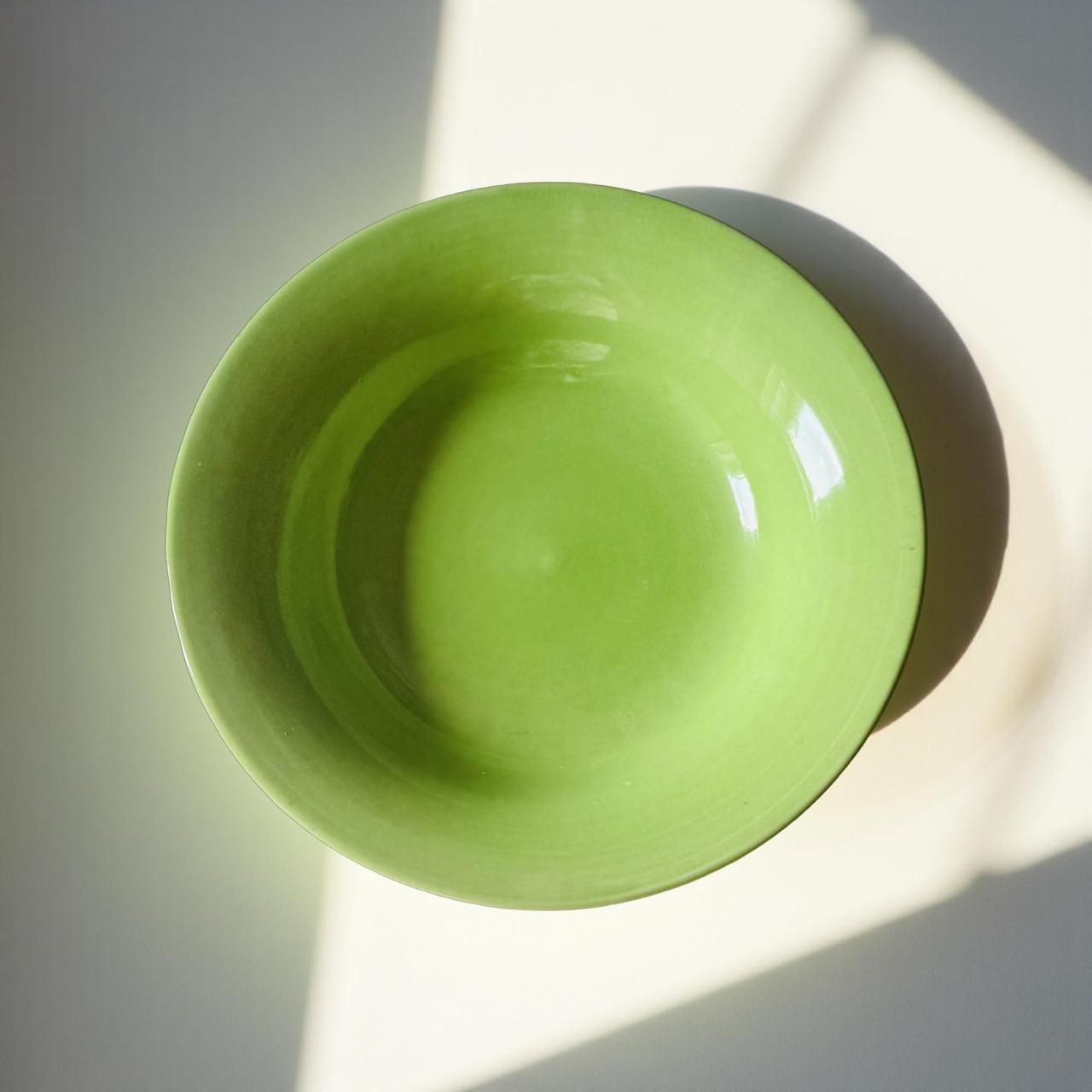 Green ceramic bowl on a light background