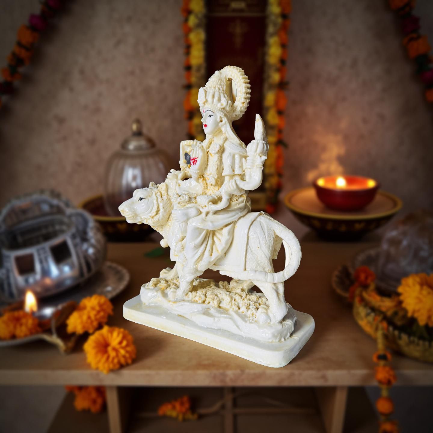 Statue of a deity on a horse with decorative background