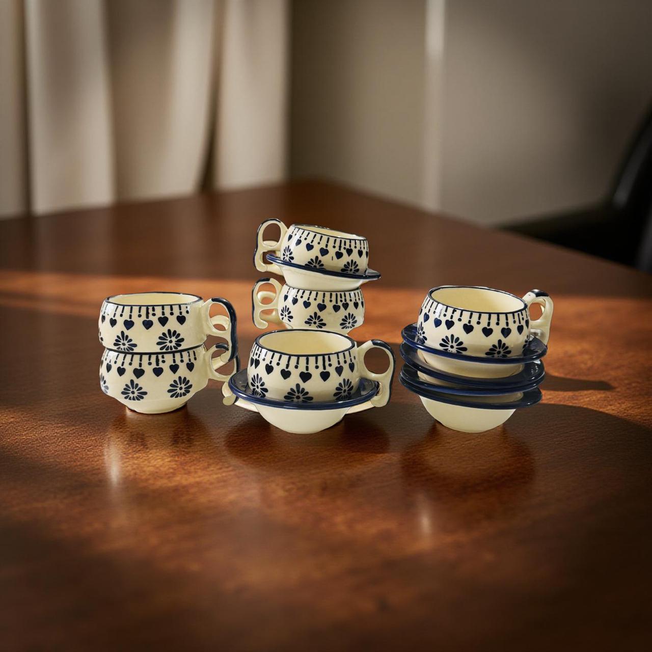 Set of ceramic cups with decorative patterns on a wooden surface
