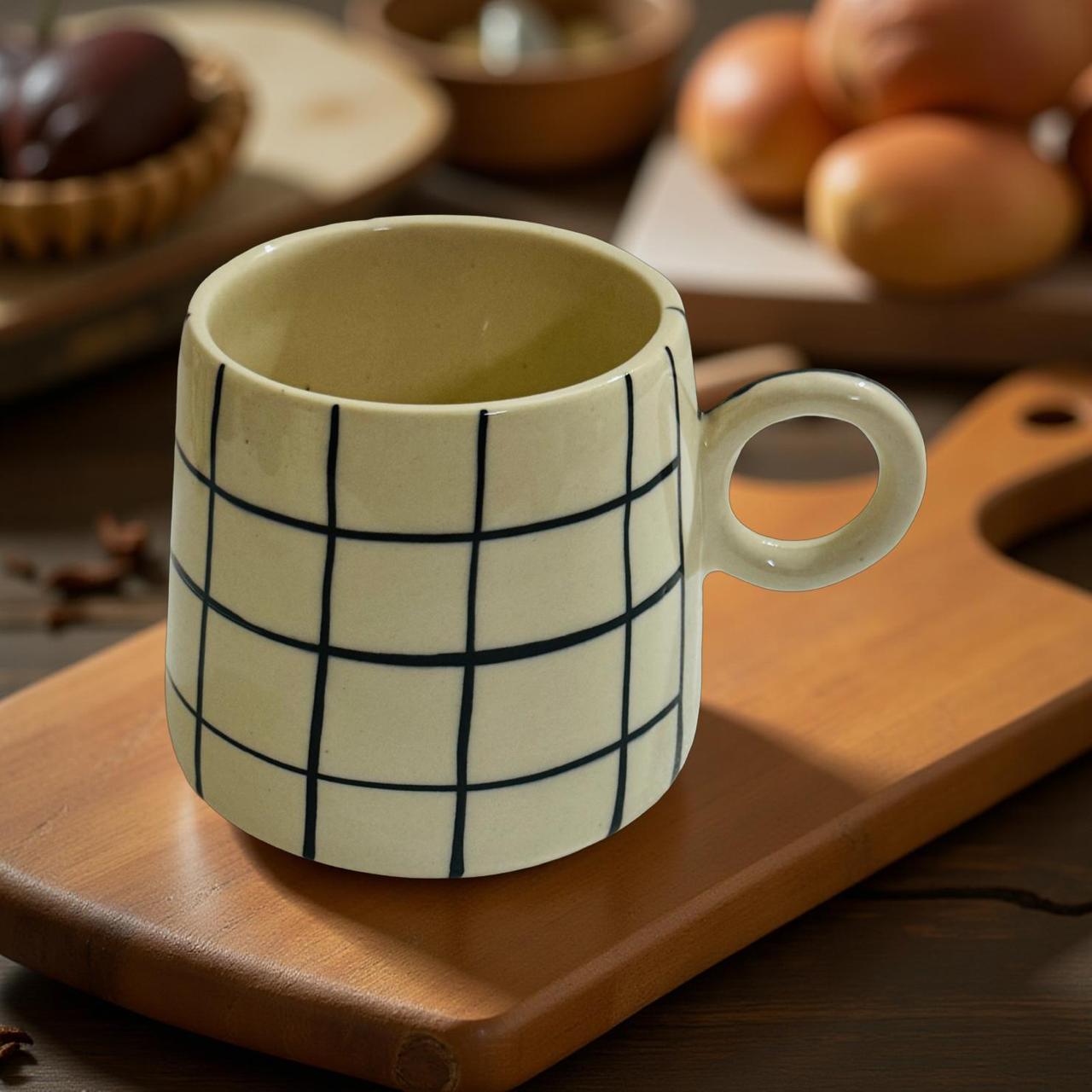 Ceramic mug with grid pattern on a wooden surface
