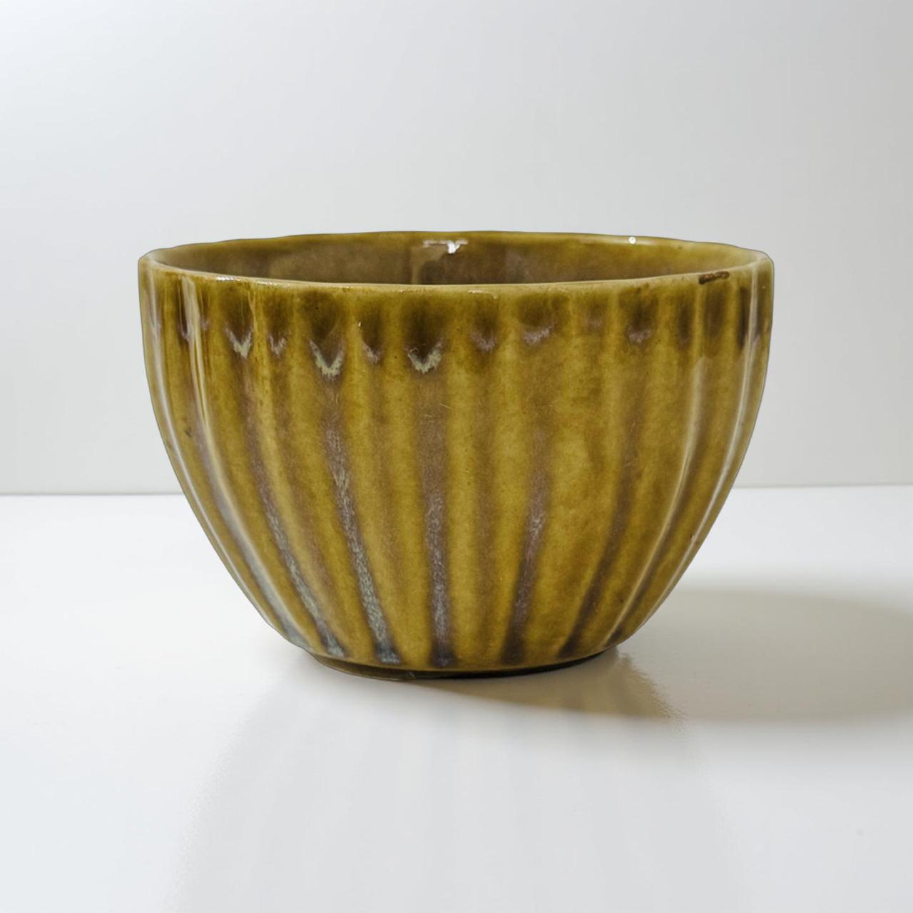  ceramic bowl with ribbed texture on a white background
