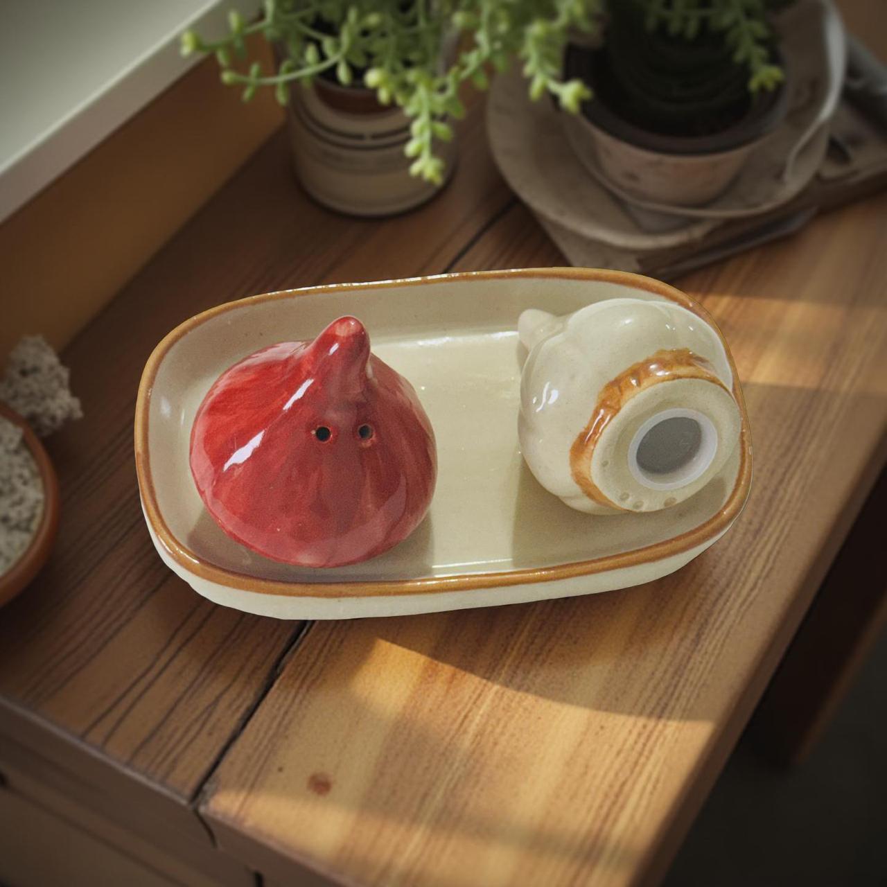 Ceramic octopus and shell on a rectangular plate with a wooden surface background