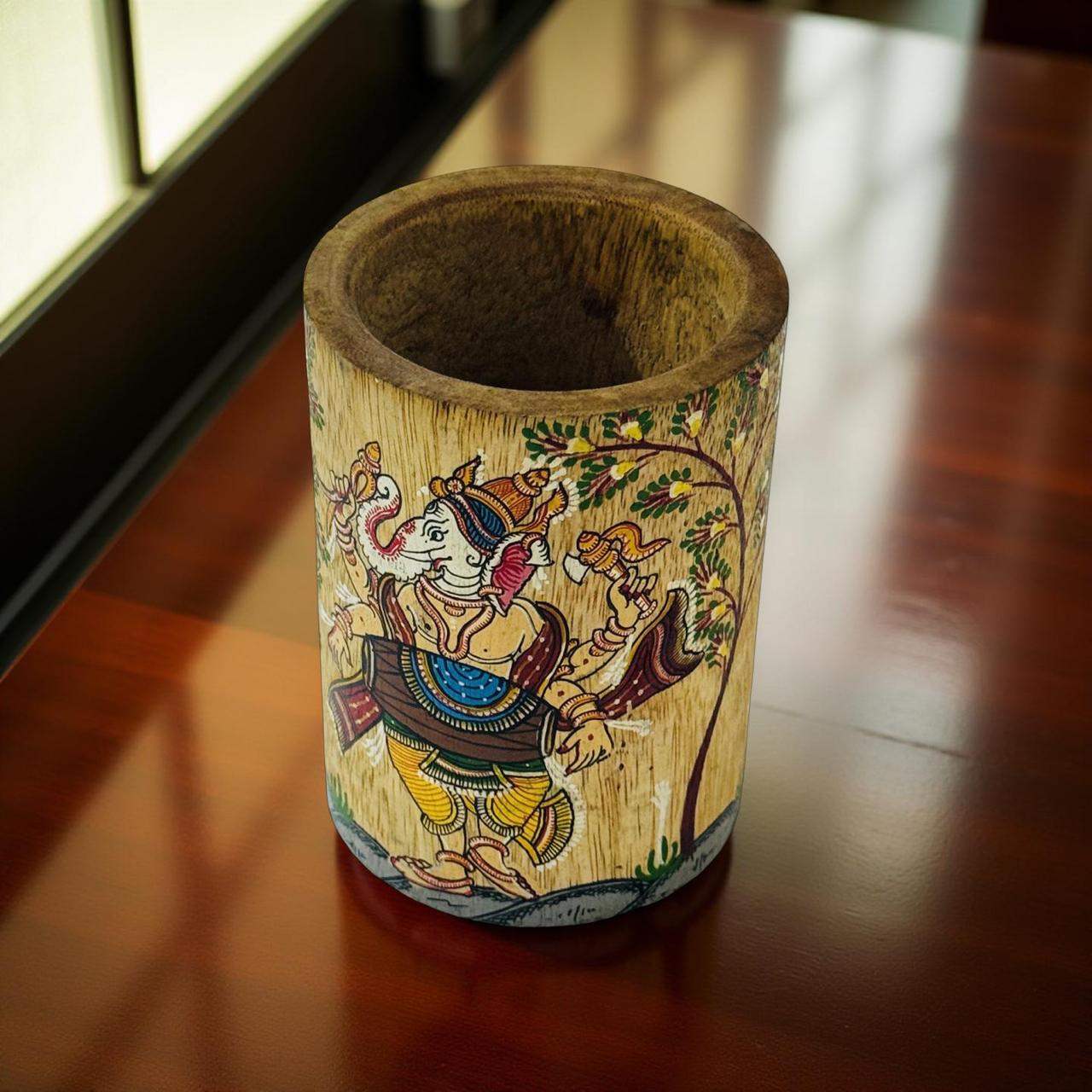 Wooden container with colorful hand-painted design on a wooden surface
