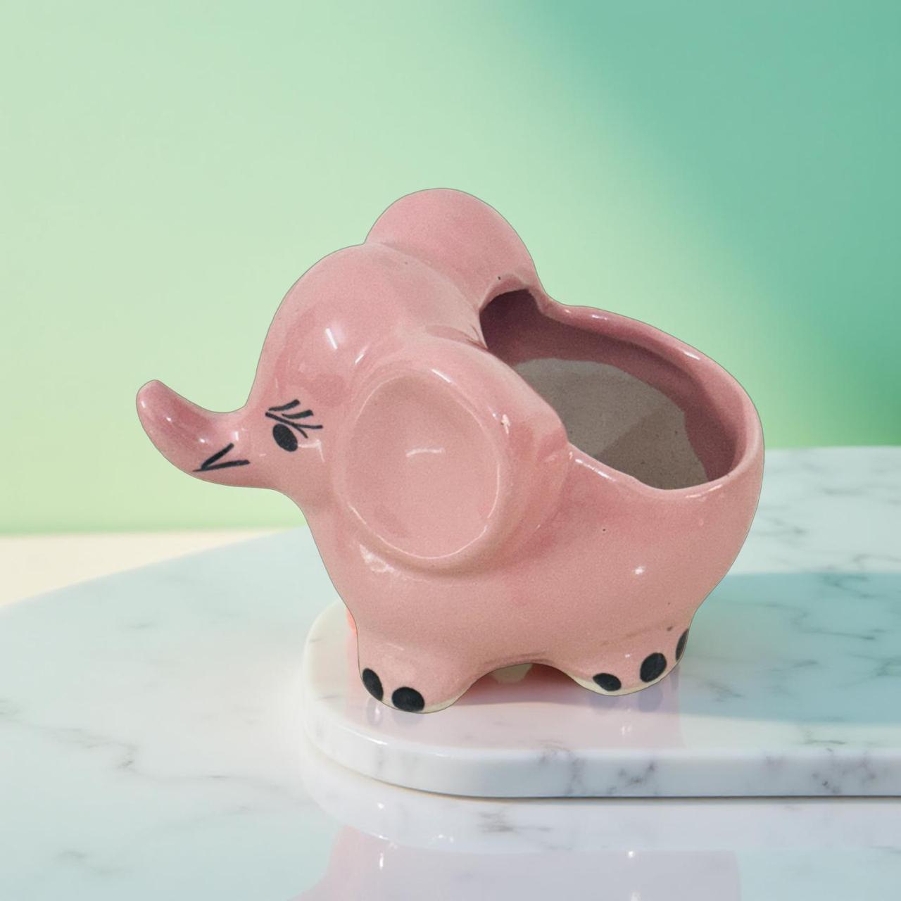 Blush pink ceramic elephant planter with green leaves