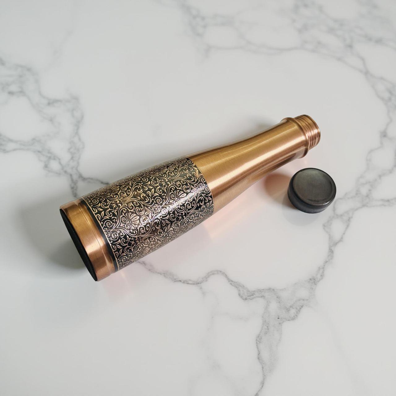 Decorative bronze bottle on a marble surface