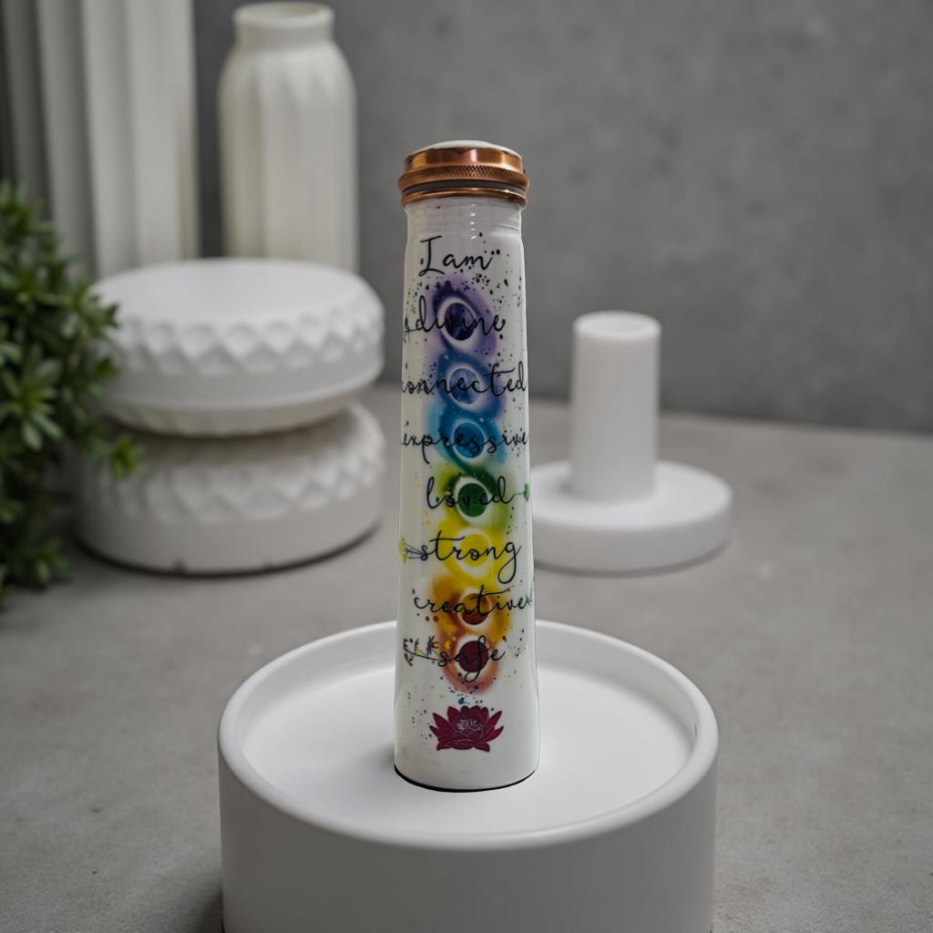 pure copper bottle with colorful text and symbols on a white stand against a neutral background