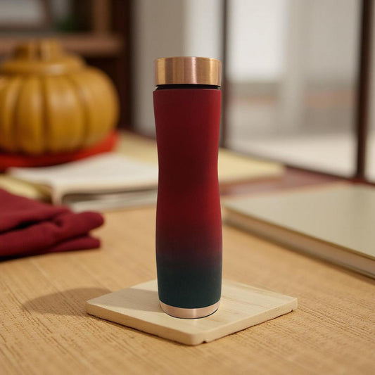 Gradient-colored tumbler on a wooden coaster with a blurred indoor background