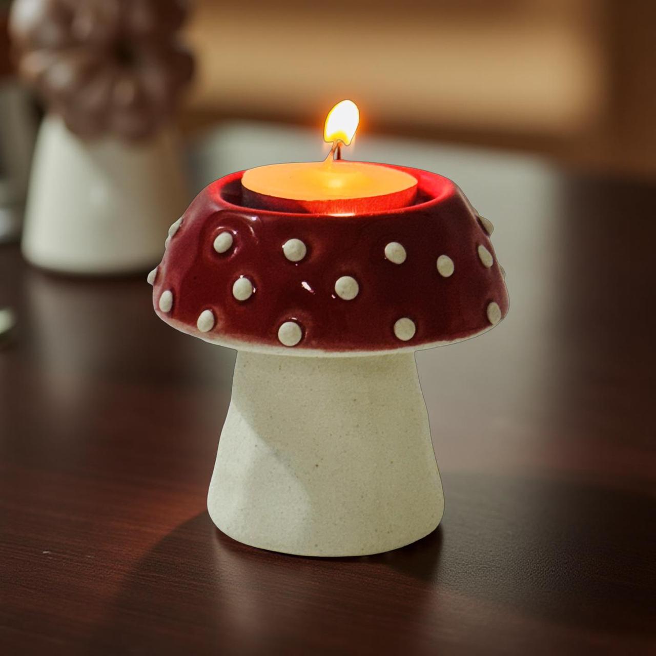 red mushroom shape candle holder kept on a wooden surface in a coy room