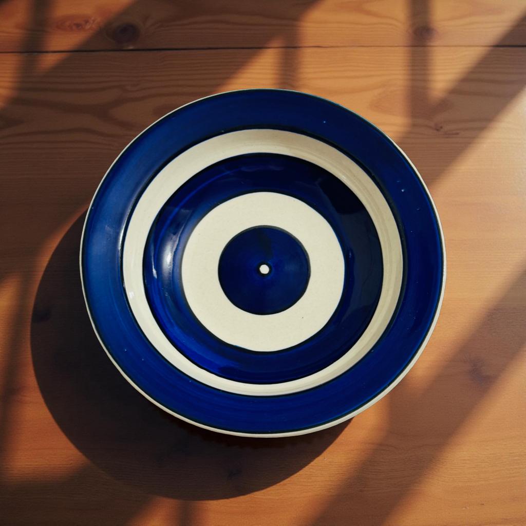 Blue and white circular dish on a wooden surface