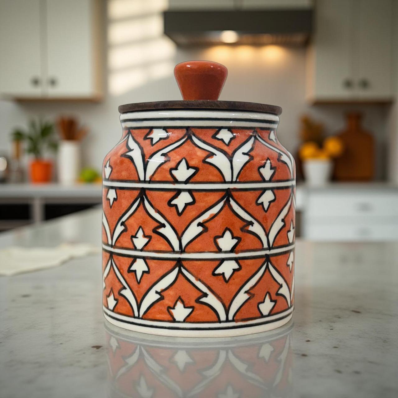 Decorative ceramic jar with orange and white pattern on a kitchen counter