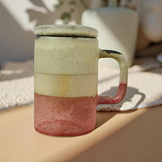 Ceramic mug with multicolored glaze on a wooden surface