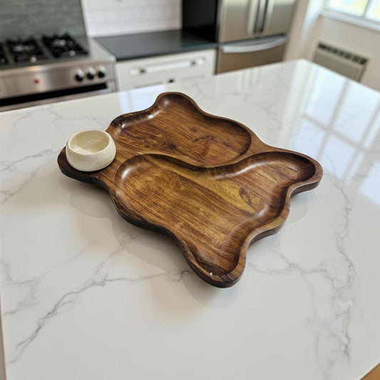 Wooden tray with a small white bowl on a marble kitchen counter