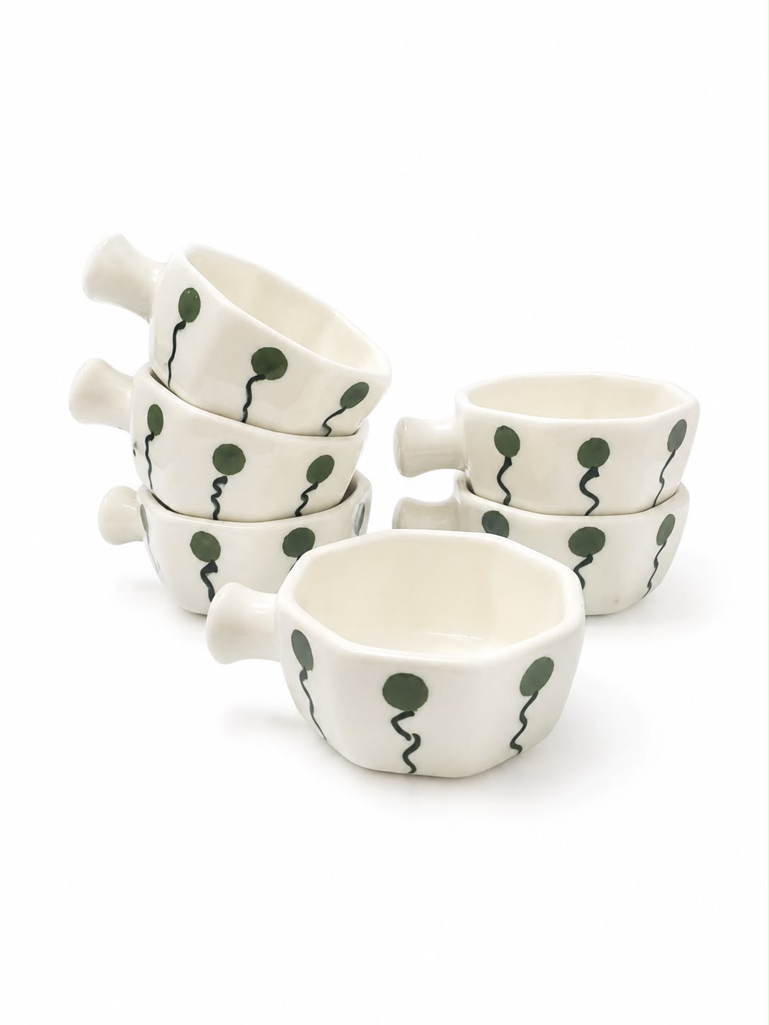 A set of six small white ceramic cups with side handles, decorated with a dark green balloon pattern, arranged on a white background.