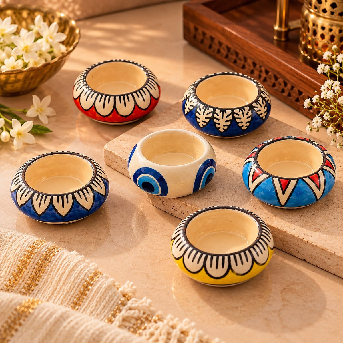 Set of six colourful hand-painted ceramic tealight holders for festive home decor