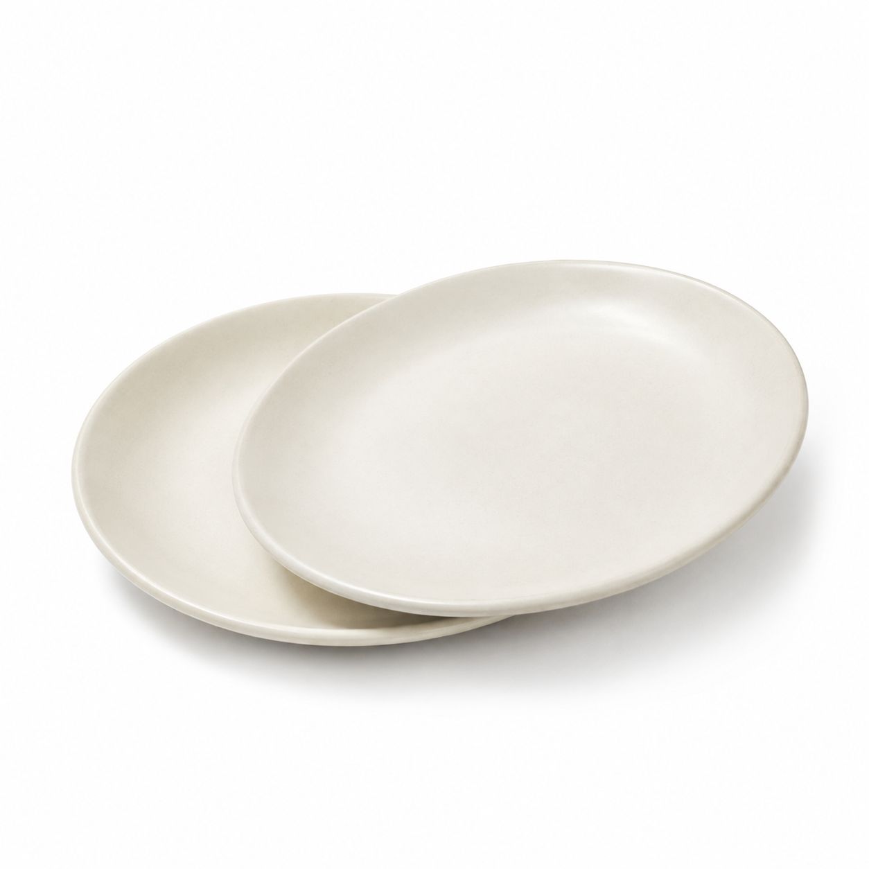 Two round ceramic plates in a warm off-white or cream color, stacked with one plate partially covering the other, on a clean white background.