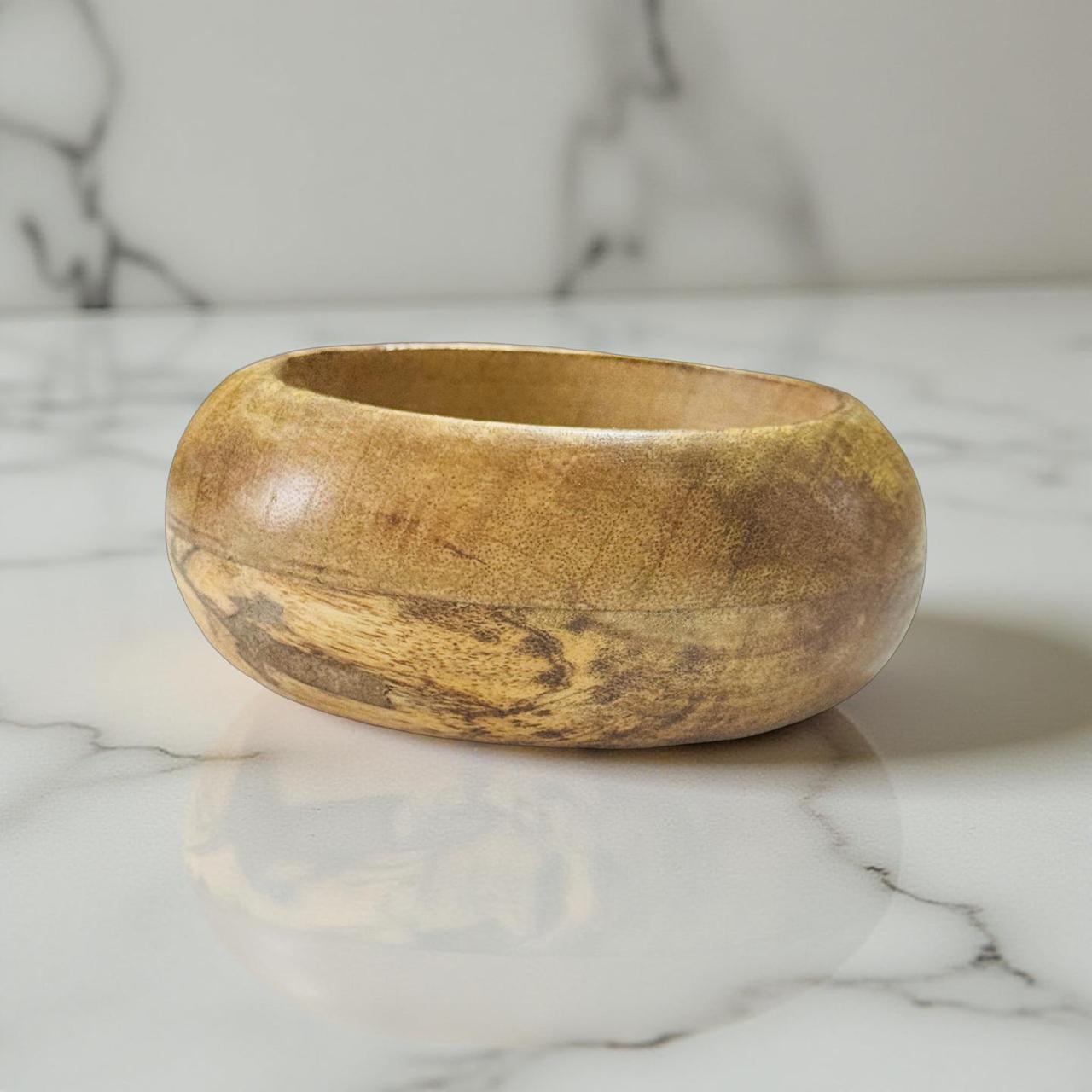 Wooden bowl on a marble surface