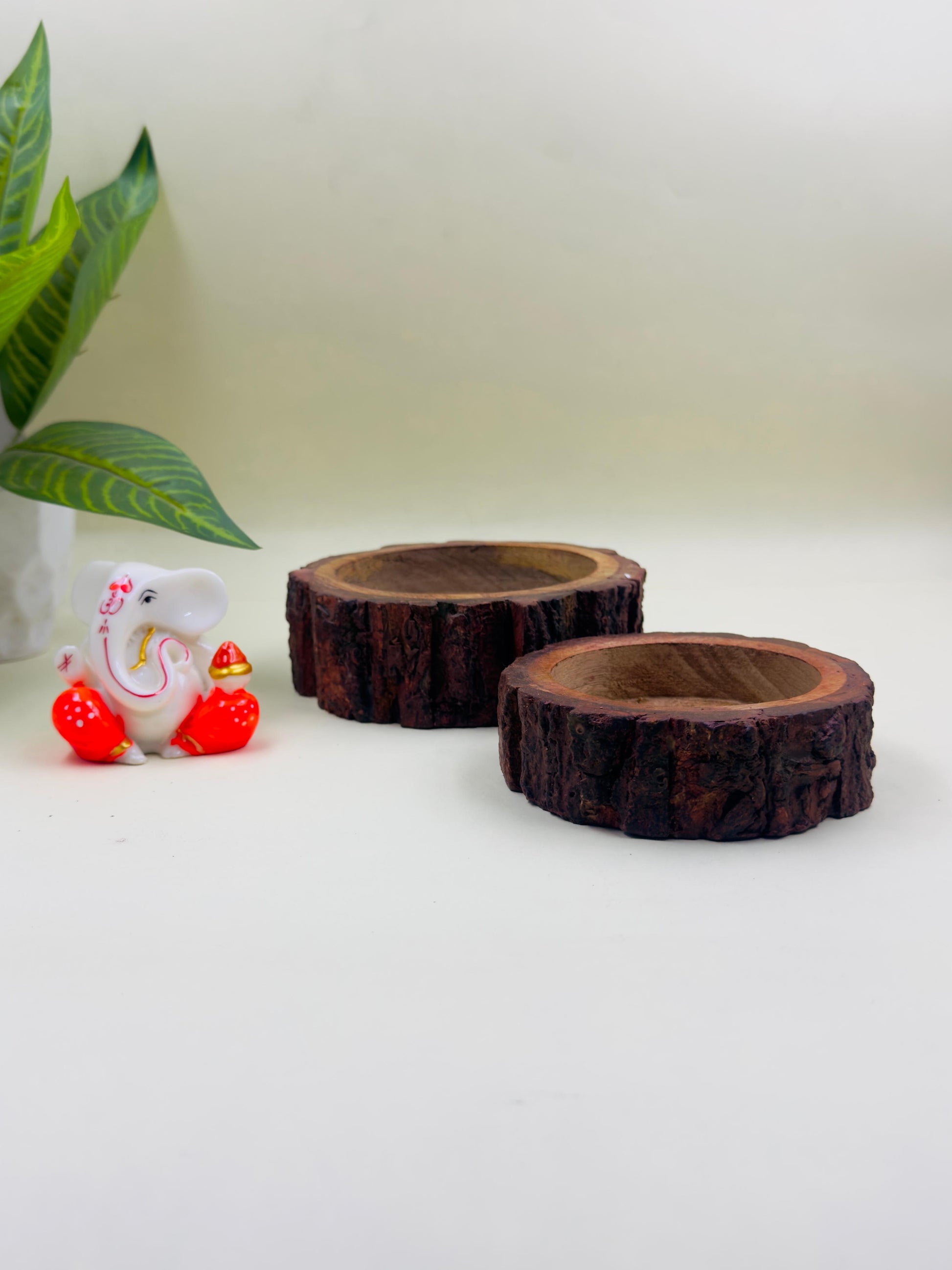 two stackable wooden decorative bowls with bark design kept against clean background