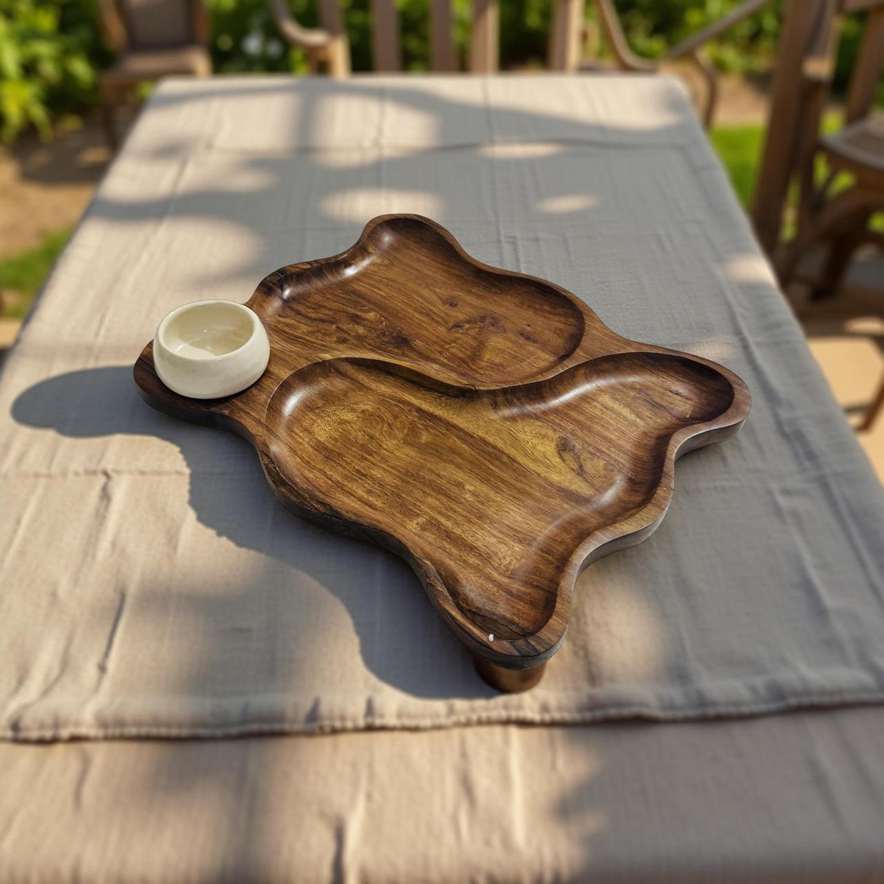 Wooden serving trays on a table outdoors