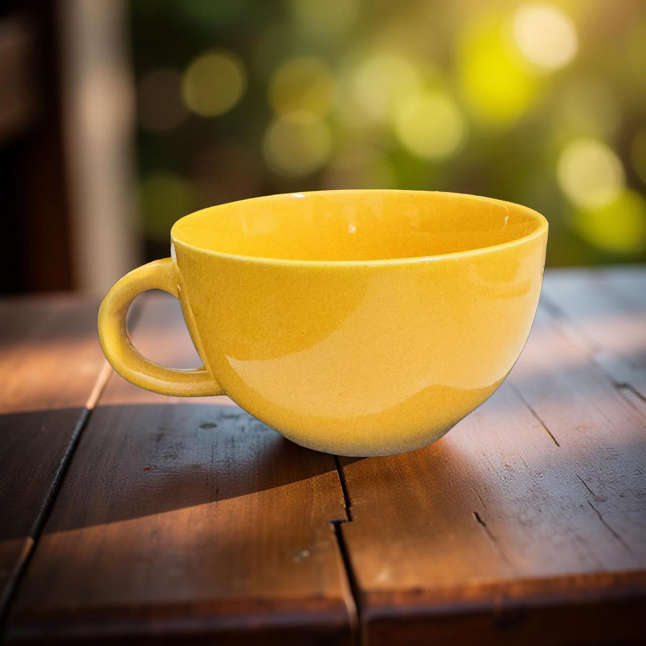 Yellow mug on a wooden table with a blurred green background