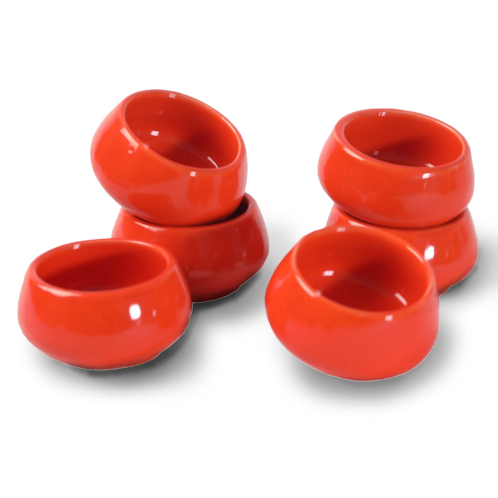 Chutney bowls with earthy glaze beside clay pots